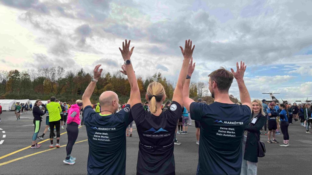 Drei Menschen, die die Hände hochreißen